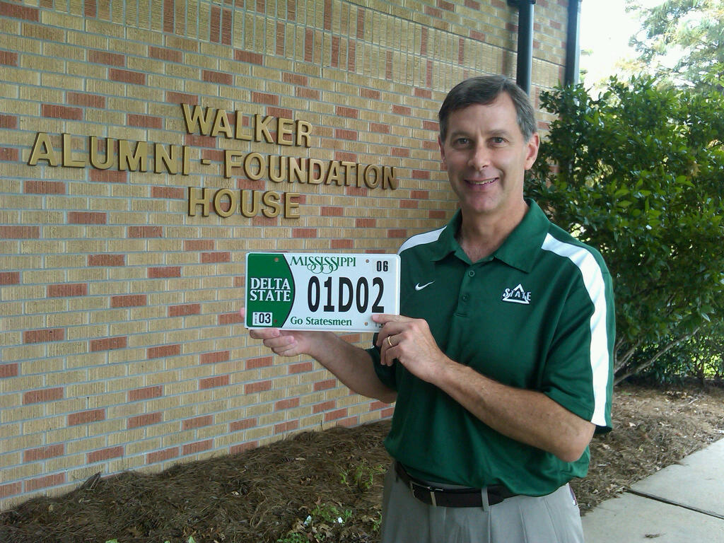 Photo: Executive Director of the Delta State University Alumni Foundation Keith Fulcher displays the new Delta State license plate.  